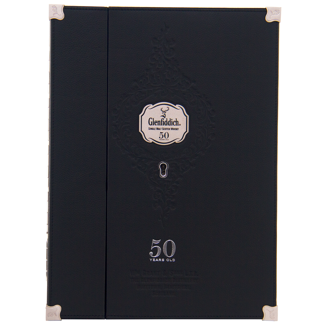 A black, elegant Glenfiddich box with silver accents and embossed patterns holds the rare Glenfiddich 50 Year Old Single Malt Scotch Whisky (Third Edition), displayed on a silver label beneath a keyhole design.
