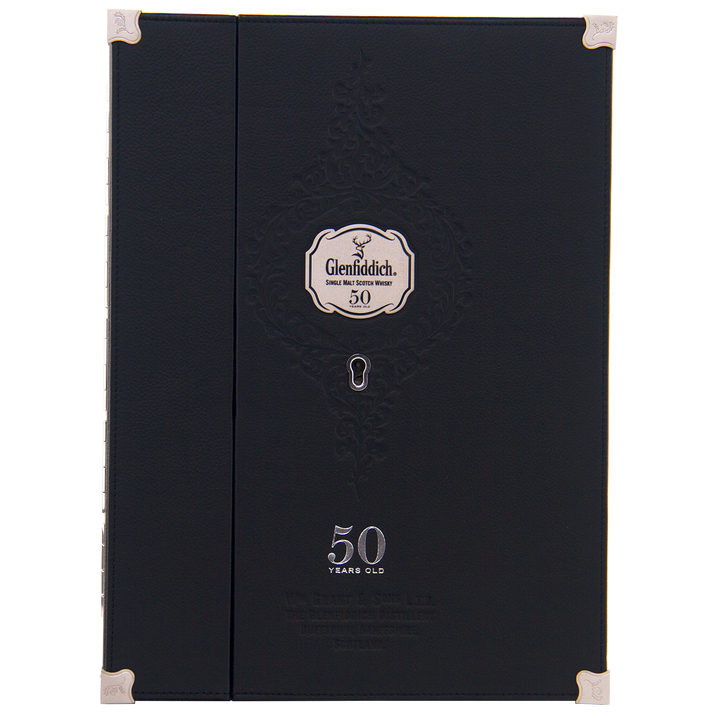 A black, elegant Glenfiddich box with silver accents and embossed patterns holds the rare Glenfiddich 50 Year Old Single Malt Scotch Whisky (Third Edition), displayed on a silver label beneath a keyhole design.