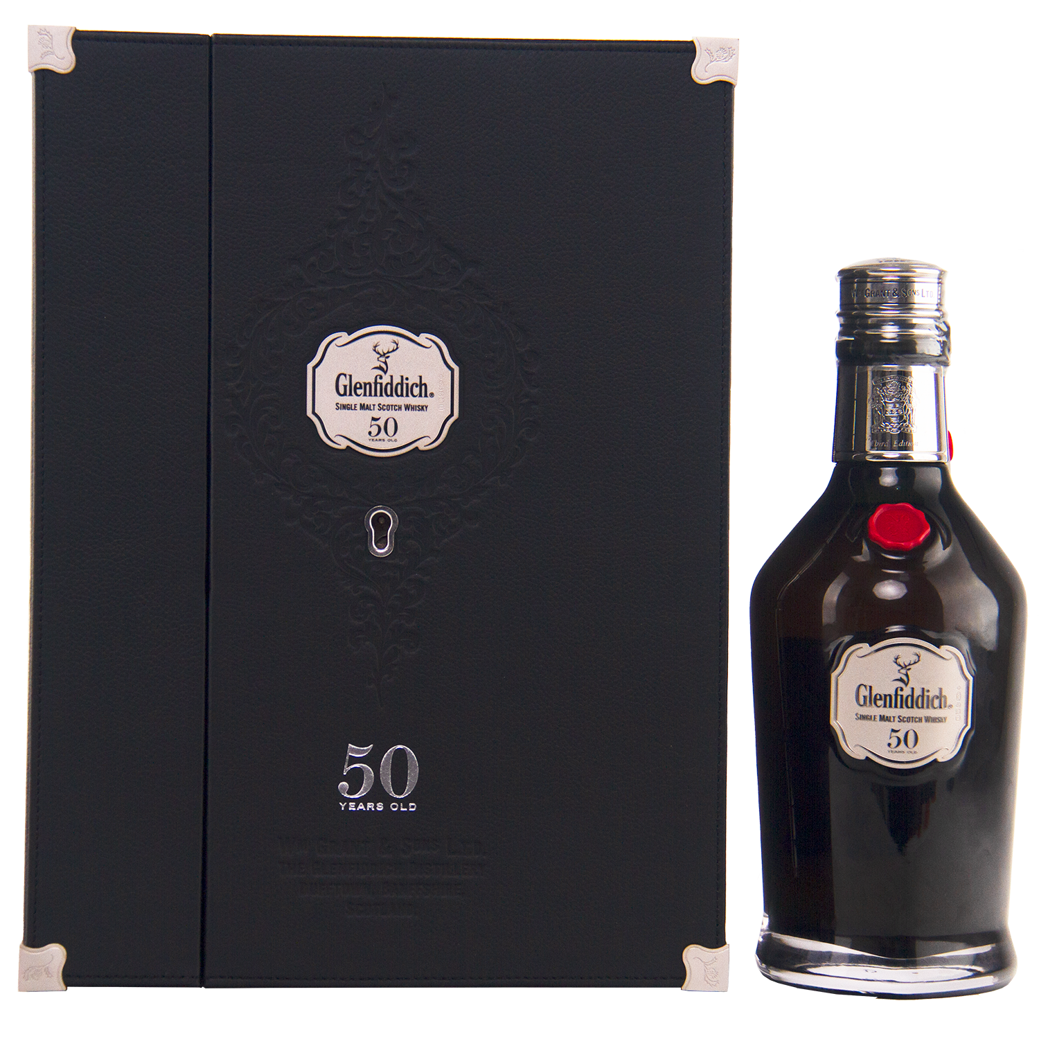 A bottle of Glenfiddich 50 Year Old Single Malt Scotch Whisky (Third Edition) stands by its elegant black box, both adorned with silver Glenfiddich logos and "50 Years Old" text—a rare collector’s whisky.