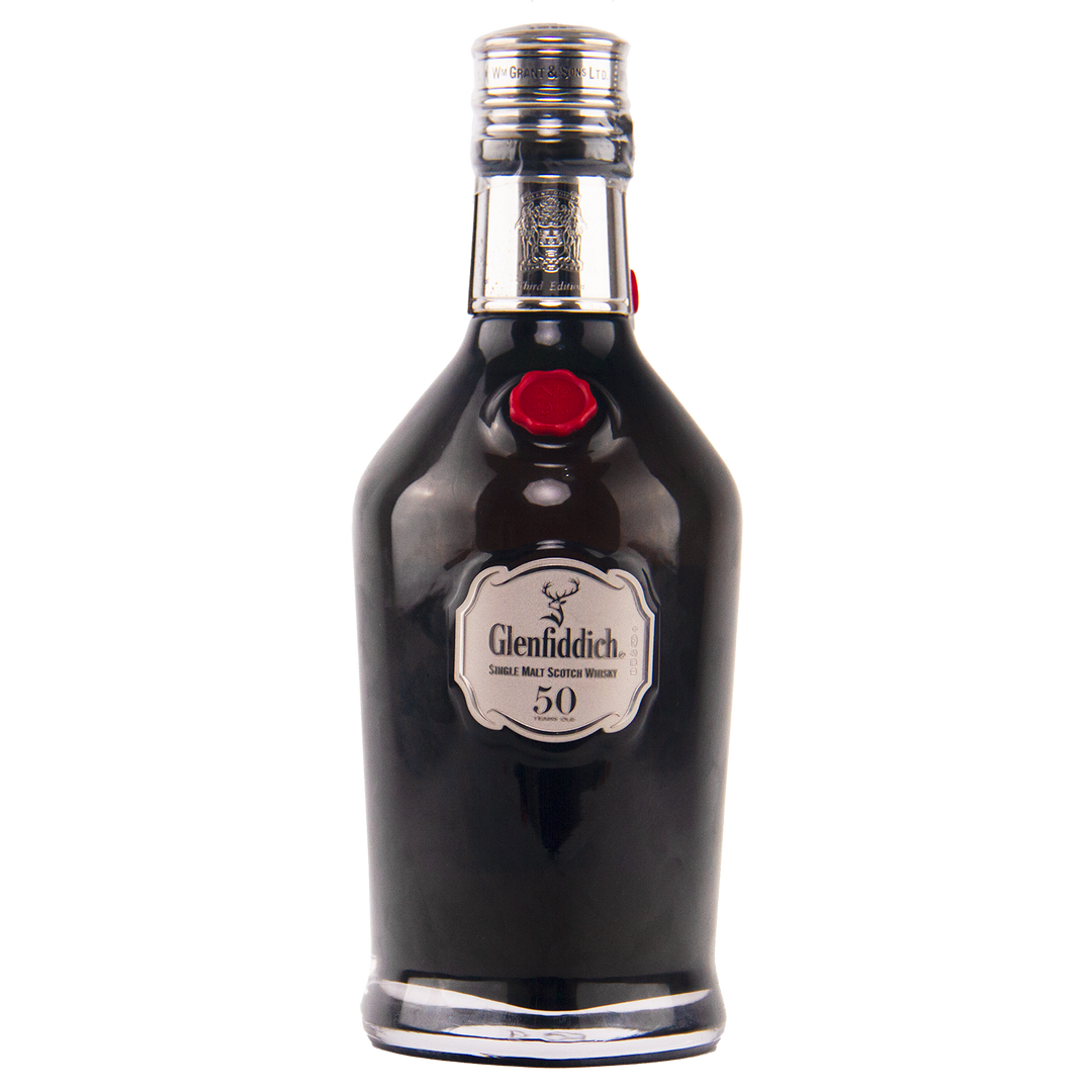 A dark glass bottle of Glenfiddich 50 Year Old Single Malt Scotch Whisky (Third Edition) features a silver label, red seal, and silver-colored cap, set against a white background.