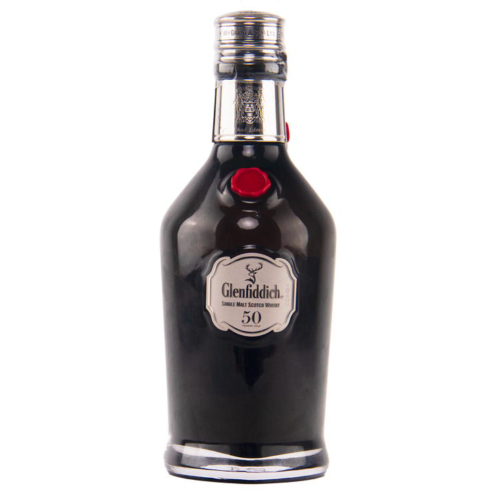A dark glass bottle of Glenfiddich 50 Year Old Single Malt Scotch Whisky (Third Edition) features a silver label, red seal, and silver-colored cap, set against a white background.