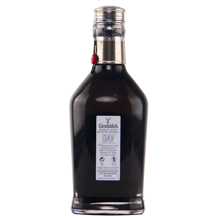 A dark glass bottle of Glenfiddich 50 Year Old Single Malt Scotch Whisky (Third Edition) with a silver cap and detailed label stands against a plain white background, showcasing the exclusivity of this rare Speyside whisky.