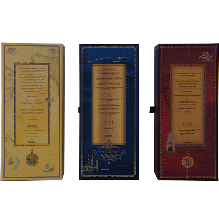 Three upright rectangular boxes—yellow, blue, and red—adorned with gold accents and intricate designs, gracefully present the Glenfiddich Age of Discovery Collection Single Malt Scotch Whisky.