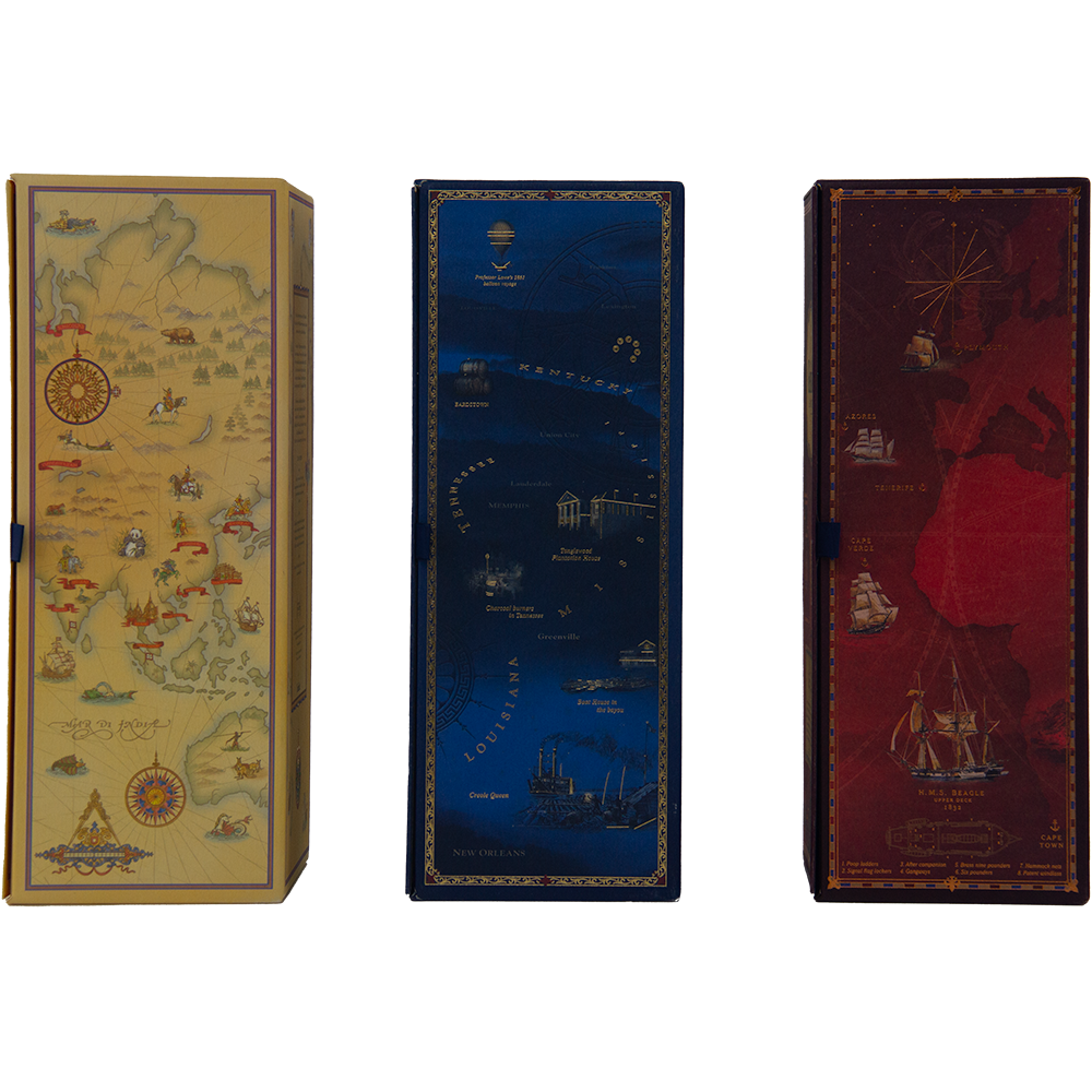Three rectangular boxes for the Glenfiddich Age of Discovery Collection: yellow with a vintage map, blue with nautical and city designs, and red featuring a ship and world map—ideal for whisky collectors.