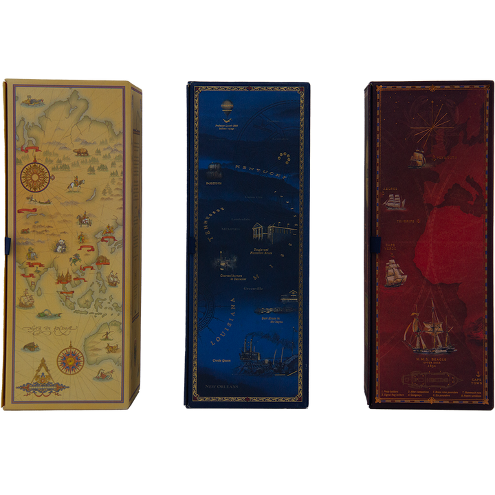 Three rectangular boxes for the Glenfiddich Age of Discovery Collection: yellow with a vintage map, blue with nautical and city designs, and red featuring a ship and world map—ideal for whisky collectors.