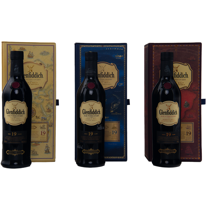 Three bottles of Glenfiddich Age of Discovery Collection Single Malt Scotch Whisky are arranged side by side, each in front of a distinctive yellow, blue, or brown box, creating a striking collector’s set on a light background.
