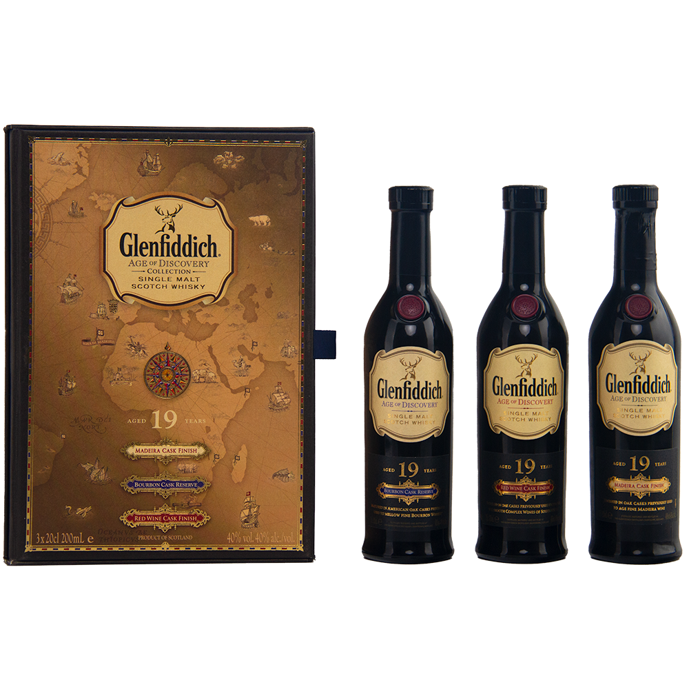 A decorative Glenfiddich Age of Discovery box with a vintage map design stands next to three 200ml bottles—an impressive Glenfiddich Age of Discovery Single Malt Scotch Whisky 3pcs gift pack.