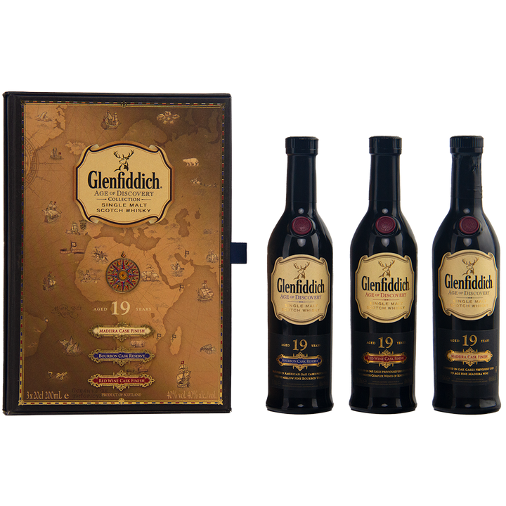 A decorative Glenfiddich Age of Discovery box with a vintage map design stands next to three 200ml bottles—an impressive Glenfiddich Age of Discovery Single Malt Scotch Whisky 3pcs gift pack.