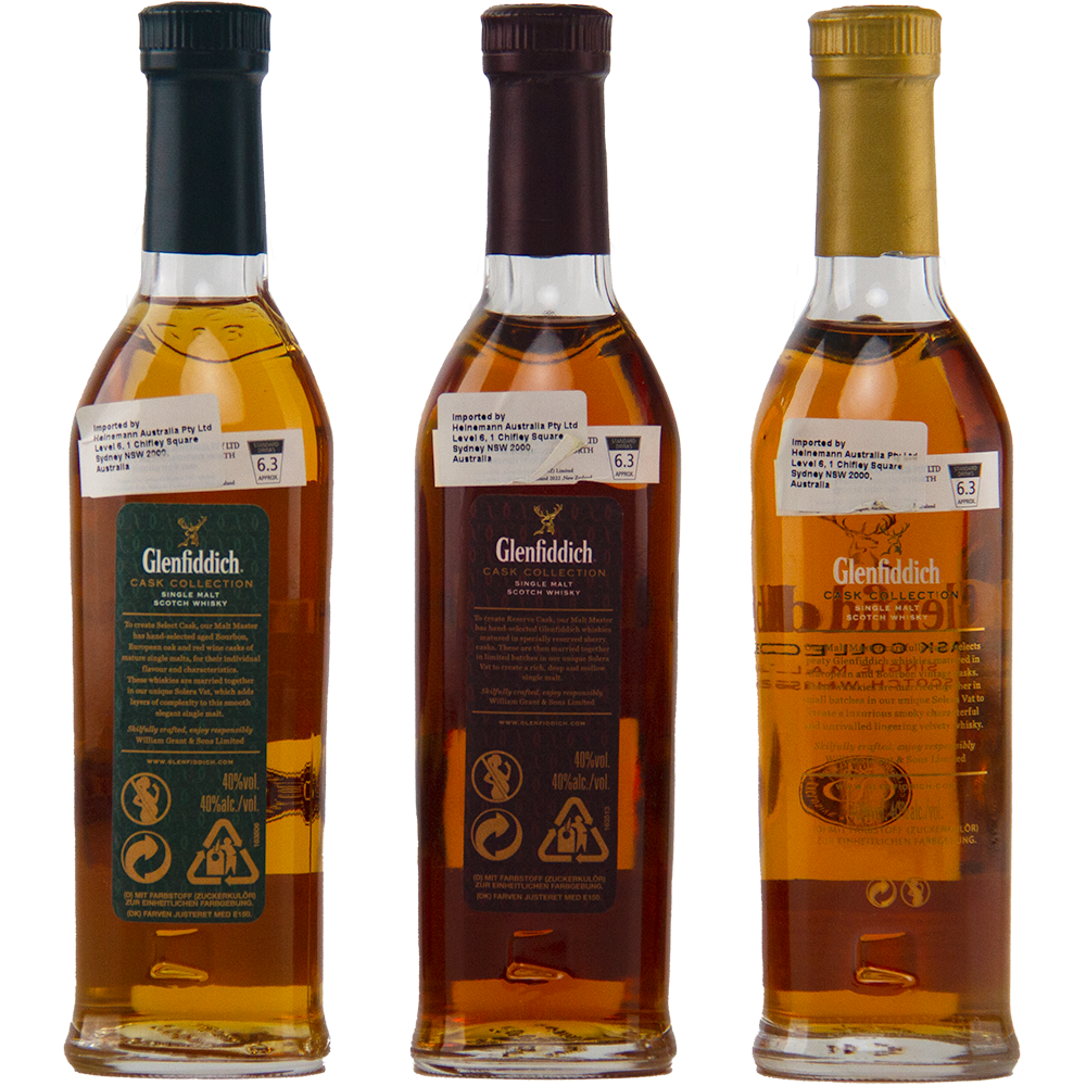 Three Glenfiddich Cask Collection Single Malt Scotch Whisky 200ml bottles with green, dark red, and gold labels are lined up with their backs showing ingredient and recycling details, the amber liquid hinting at the rich flavors inside.