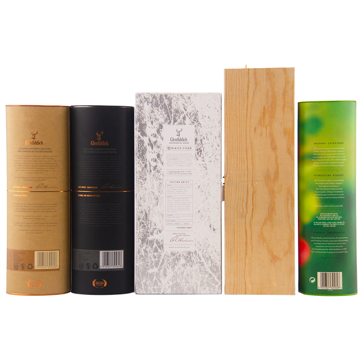 Five upright Glenfiddich Experiment Series 1-5 Single Malt Scotch Whisky packages—brown, black, marble-patterned white, natural wood, and green with fruit design—are displayed from the back on a white background.