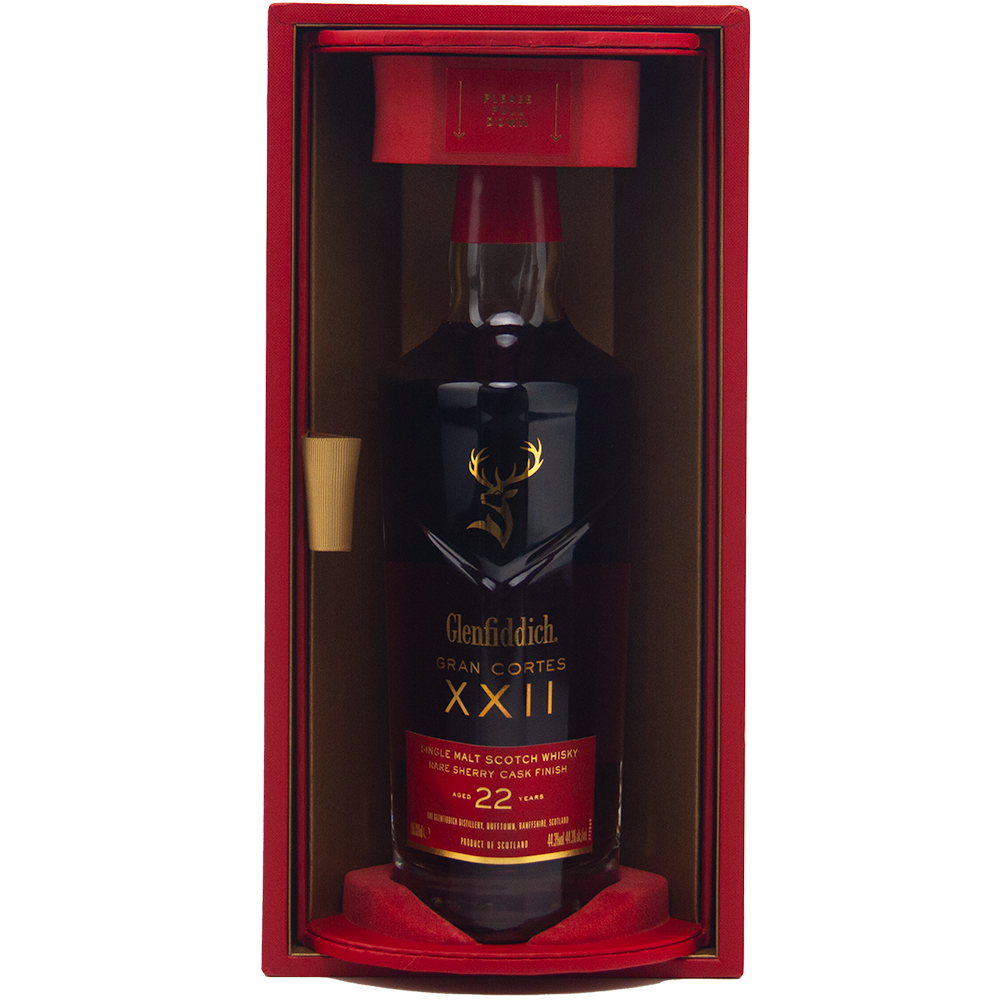 A bottle of Glenfiddich Gran Cortes XXII Single Malt Scotch Whisky, finished in rare Palo Cortado casks, comes in a striking red and gold display box with gold lettering and a stag logo on the dark bottle.