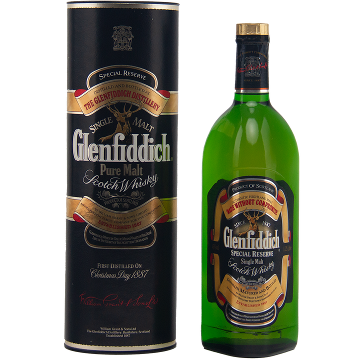 A green bottle of Glenfiddich Pure Malt Whisky Single Malt Scotch Whisky 1125ml stands beside its black cylindrical box, both with gold, red, and cream labels—a striking vintage collectible for whisky enthusiasts seeking a large-format bottle.