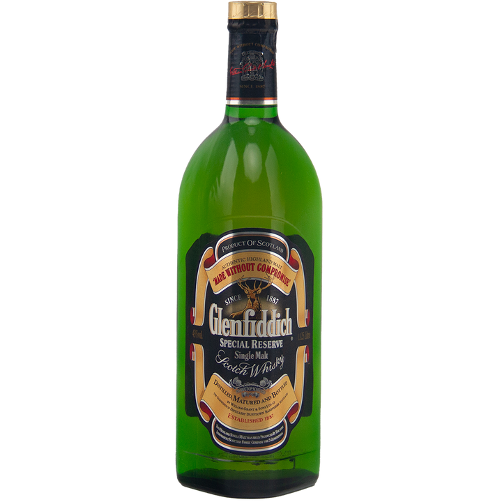 A vintage collectible 1125ml green bottle of Glenfiddich Pure Malt Whisky Single Malt Scotch Whisky with a gold and black label and gold foil seal on the cap.