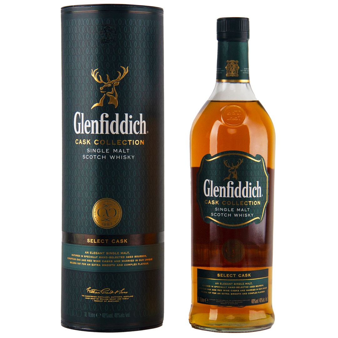 A bottle of Glenfiddich Cask Collection Select Cask Single Malt Scotch Whisky stands beside its tall green-and-gold cylindrical packaging, both adorned with a stag logo and refined branding in this travel-retail exclusive.