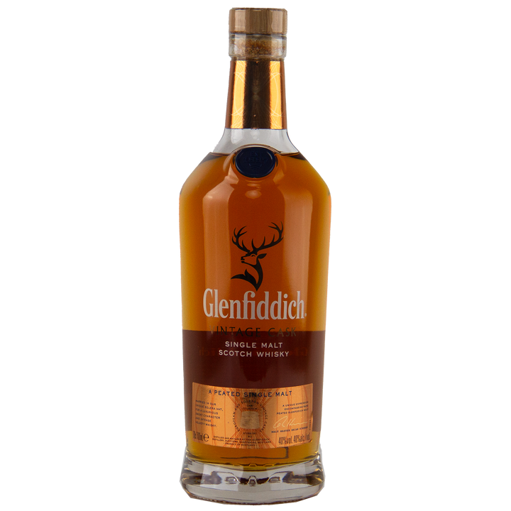A bottle of Glenfiddich Vintage Cask Single Malt Scotch Whisky with an amber liquid, brown label, and wooden cap stands upright on a white background—ideal as a travel retail exclusive.