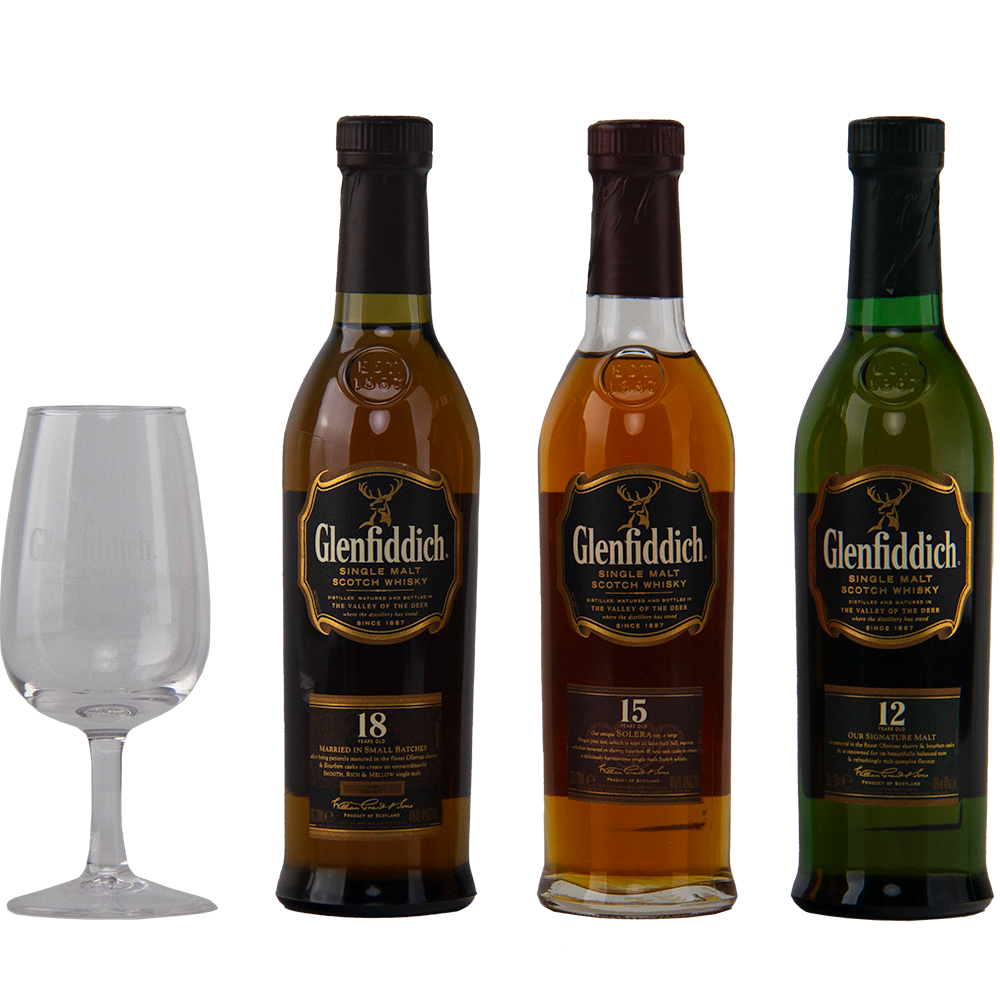 Three Glenfiddich Explorers Collection Single Malt Scotch Whisky 200ml bottles (18, 15, and 12 years) stand beside an empty Glenfiddich glass, set against a plain white background.