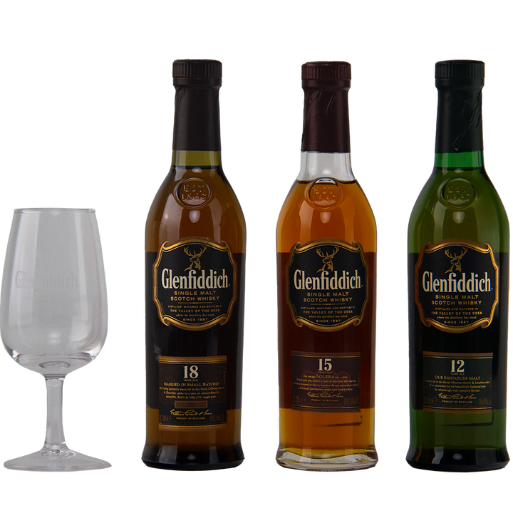 Three Glenfiddich Explorers Collection Single Malt Scotch Whisky 200ml bottles (18, 15, and 12 years) stand beside an empty Glenfiddich glass, set against a plain white background.