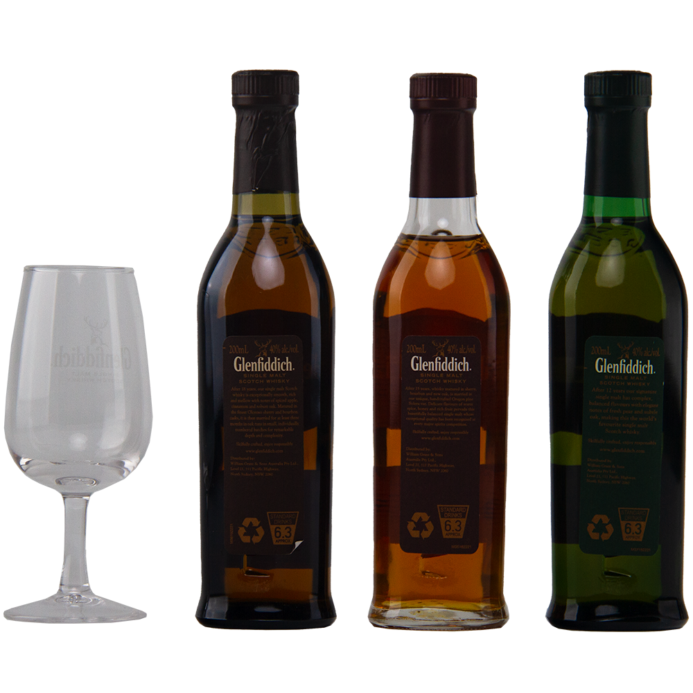 Three bottles of Glenfiddich Explorers Collection Single Malt Scotch Whisky 200ml, each with a different colored liquid, are arranged beside an empty Glenfiddich-branded glass on a plain white background.