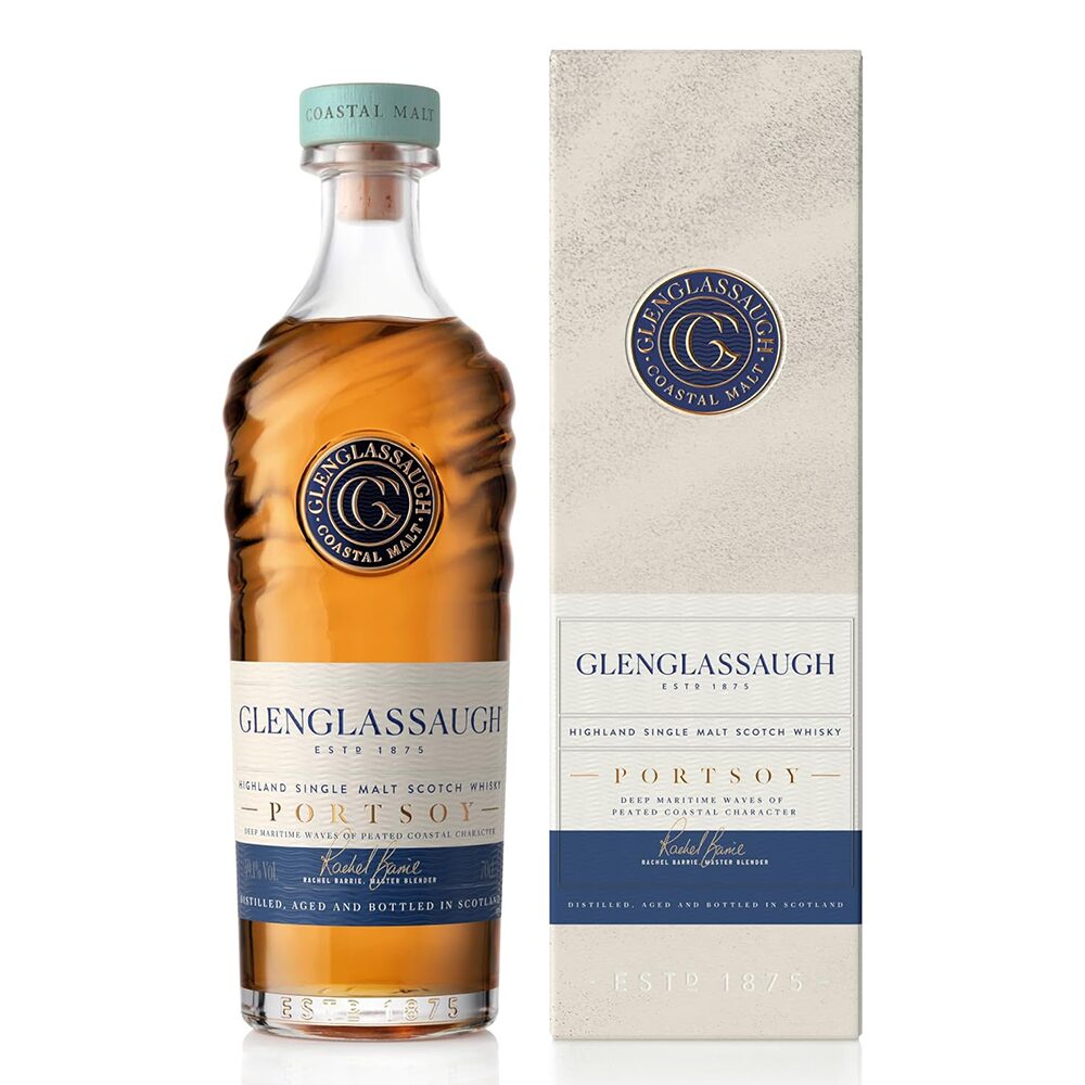 A bottle of Glenglassaugh Portsoy Single Malt Scotch Whisky stands beside its matching box, both with blue and gold accents and the Glenglassaugh logo. The bottle reveals the rich amber hue of this maritime-inspired peated whisky.