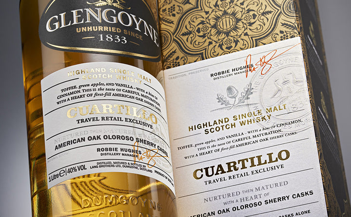 Close-up of a Glengoyne Cuartillo Single Malt Scotch Whisky bottle with its ornate packaging, showcasing the detailed label and emphasizing its travel retail exclusivity.