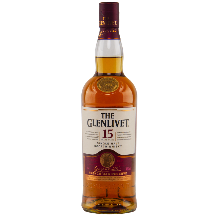 A bottle of Glenlivet 15 Year Old Single Malt Whisky, featuring a cream and gold label with maroon accents plus a gold foil neck seal, from the French oak reserve collection.