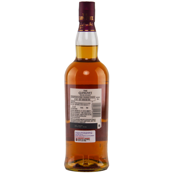 A bottle of Glenlivet 15 Year Old Single Malt Whisky is shown from the back on a white background, highlighting the label with product details and barcode.