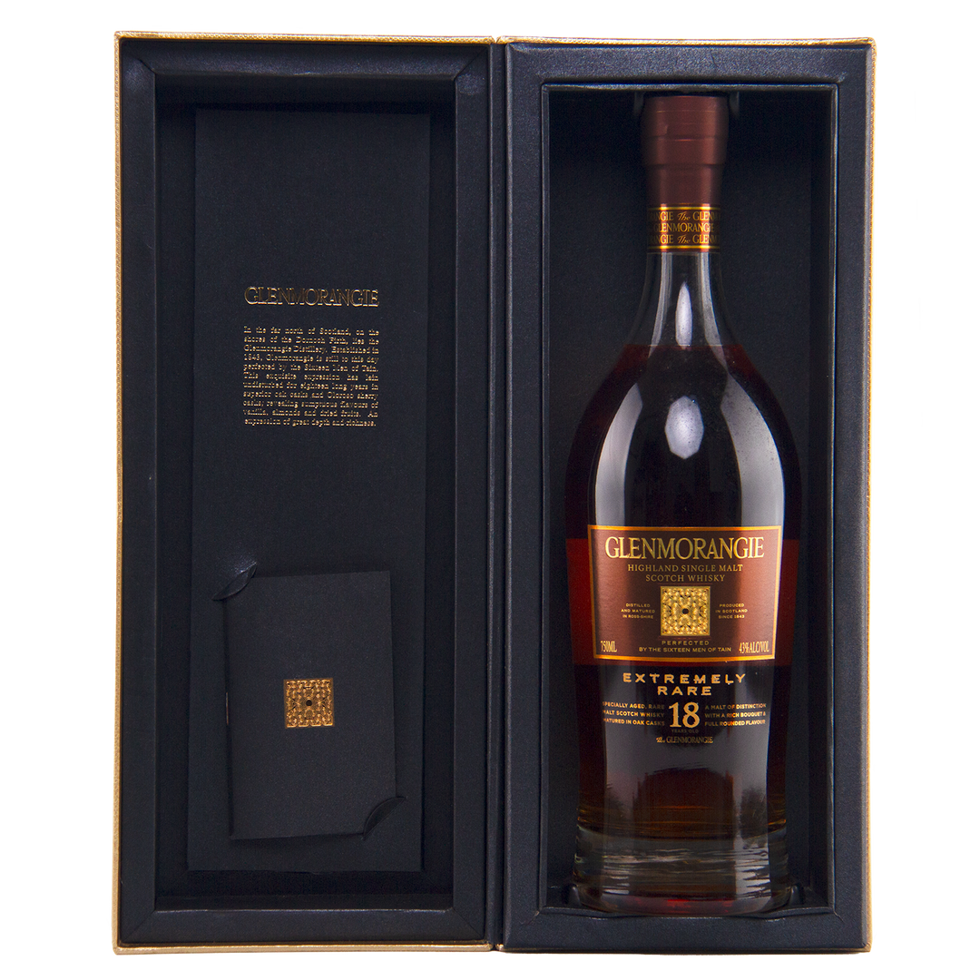 A bottle of Glenmorangie 18 Year Old Extremely Rare (Older Packaging) Highland single malt Scotch whisky displayed in an open black gift box with gold detailing and an inscription inside the cover.