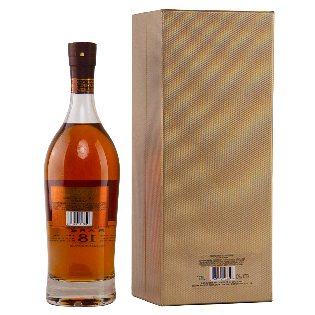 A bottle of Glenmorangie 18 Year Old Extremely Rare (Older Packaging) with a brown cap stands next to a tall, gold textured box. Both display barcode labels, set against a plain white background.