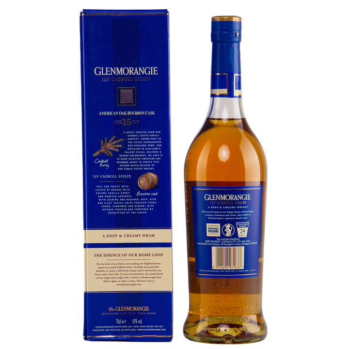 A bottle of Glenmorangie The Cadboll 15 Year Old Single Malt Whisky is placed beside its blue box, both featuring gold and white text highlighting detailed product information and branding.