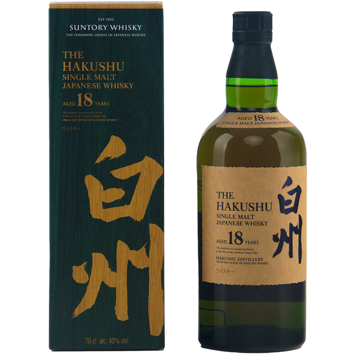 A bottle of Hakushu 18 Year Old Single Malt Whisky stands next to its dark green box with gold Japanese calligraphy and English text. The bottle has a green cap and an elegant gold label.