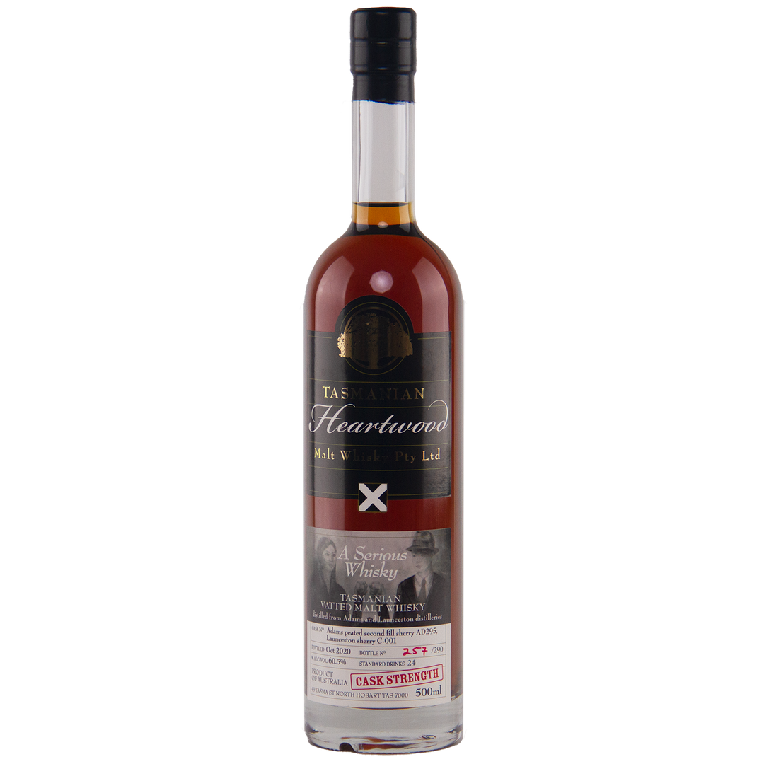 A bottle of Heartwood A Serious Whisky Australian Single Malt Whisky with a dark label, gold and white text, a red wax seal on the neck, and a lower label featuring whisky details and a black-and-white photo of two people.