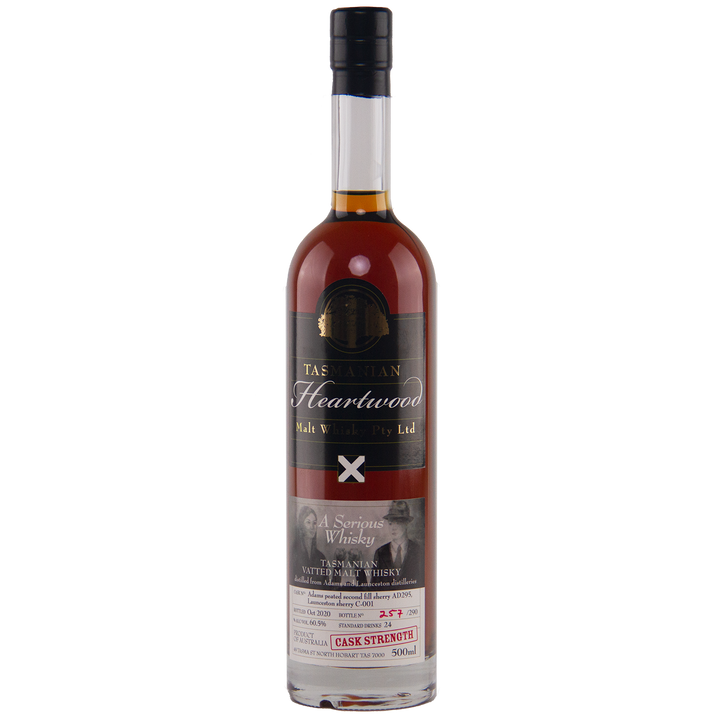 A bottle of Heartwood A Serious Whisky Australian Single Malt Whisky with a dark label, gold and white text, a red wax seal on the neck, and a lower label featuring whisky details and a black-and-white photo of two people.
