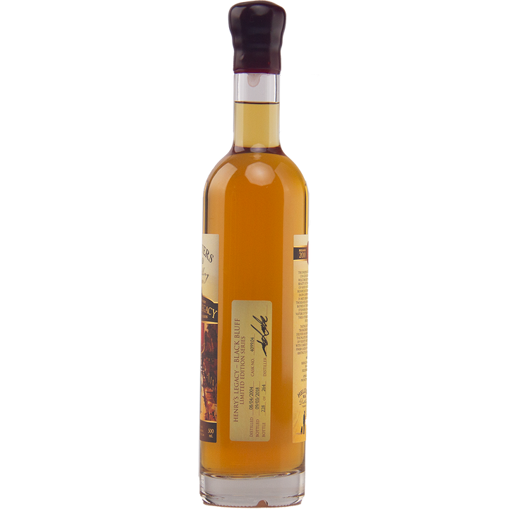 A tall, slender bottle of Hellyers Road Henry's Legacy Series Black Buff Australian Single Malt Whisky, filled with amber liquid and sealed with dark wax. Two labels display text, a signature, an image, and further product details.