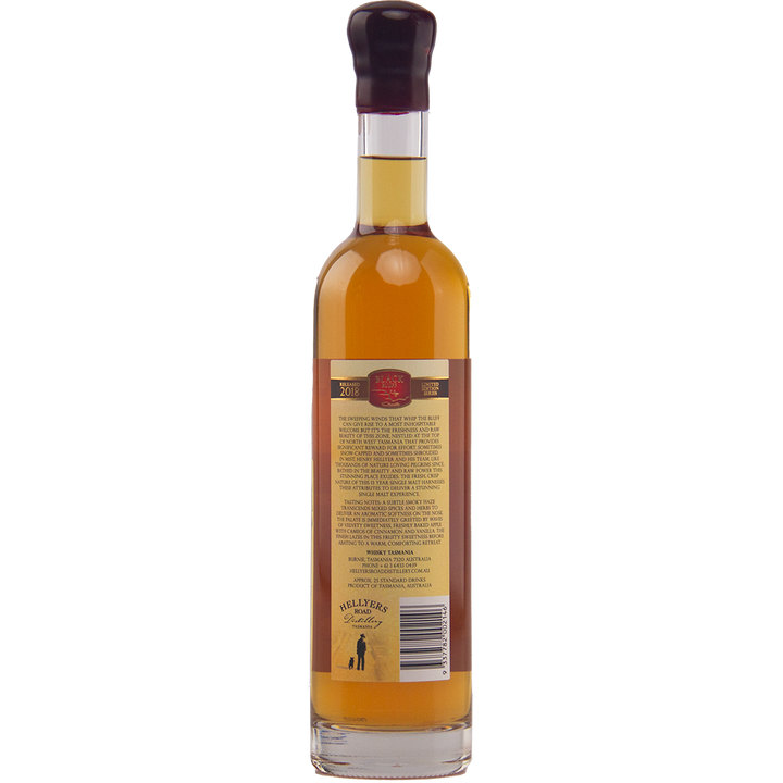 A tall, clear bottle of Hellyers Road Henry's Legacy Series Black Buff Australian Single Malt Whisky, filled with amber liquid, shown from the back with a label and small black logo near the base. The bottle is sealed with dark wax.