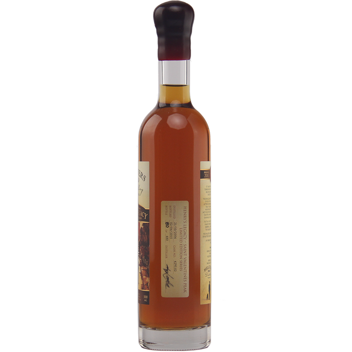A tall, clear glass bottle filled with amber liquid, sealed with a dark cap and a rectangular side label—this is Hellyers Road Saint Valentines Peak Australian Single Malt Whisky.