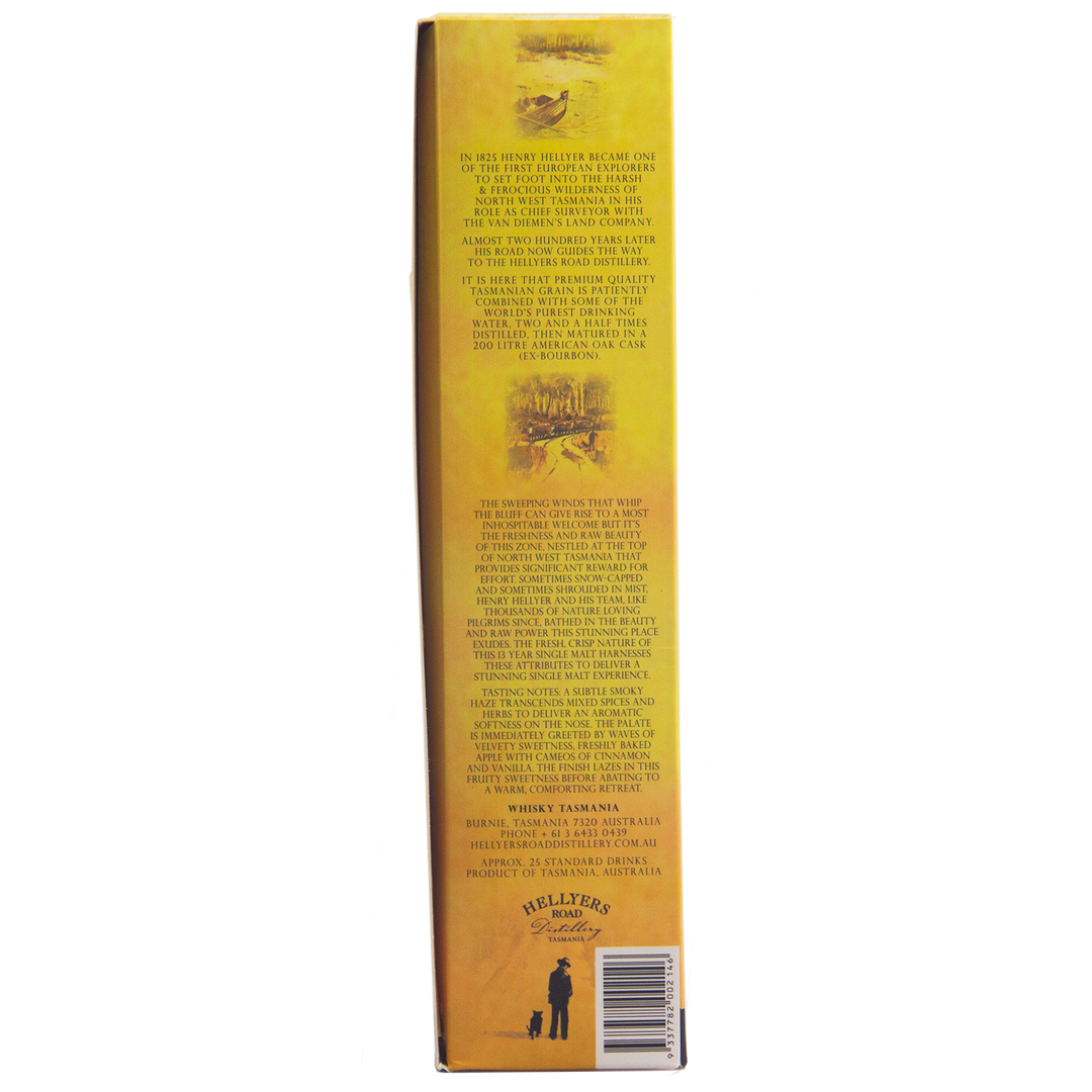 Side view of a yellow Hellyers Road Saint Valentines Peak Australian Single Malt Whisky box showing detailed printed text about this Tasmanian whisky’s history, with small illustrations and a man and dog logo in the bottom corner.
