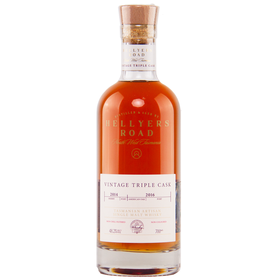 A bottle of Hellyers Road Vintage Triple Cask Australian Single Malt Whisky, featured by The Whisky Club, with a cork stopper, white label, and amber liquid inside.