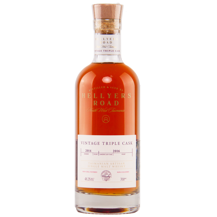 A bottle of Hellyers Road Vintage Triple Cask Australian Single Malt Whisky, featured by The Whisky Club, with a cork stopper, white label, and amber liquid inside.