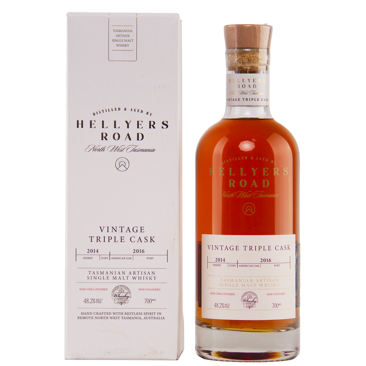 A bottle of Hellyers Road Vintage Triple Cask Australian Single Malt Whisky stands beside its white box, both adorned with gold and red lettering highlighting cask years, origin, and volume—an exclusive for The Whisky Club.