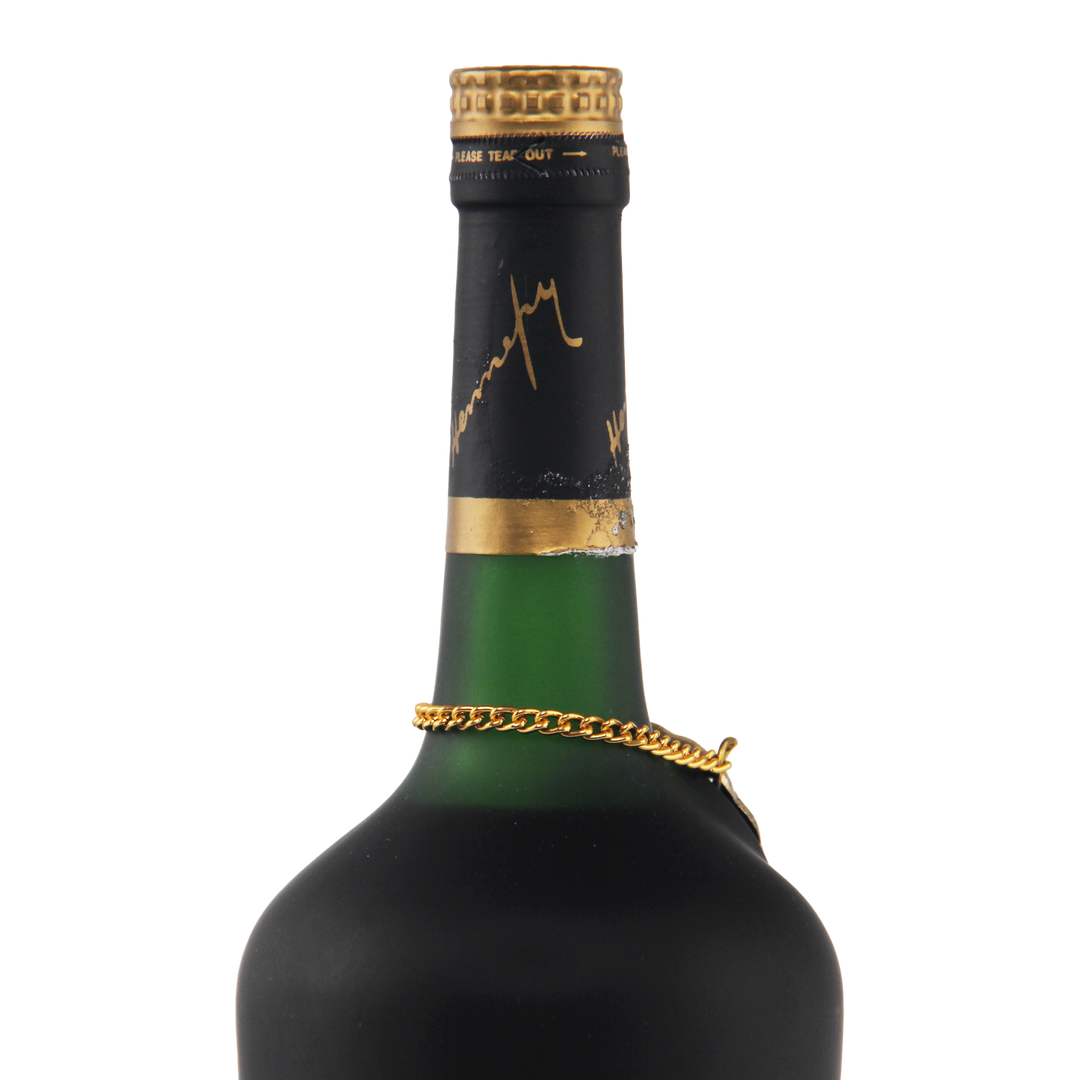 Green wine bottle with gold foil cap and chain on a white background