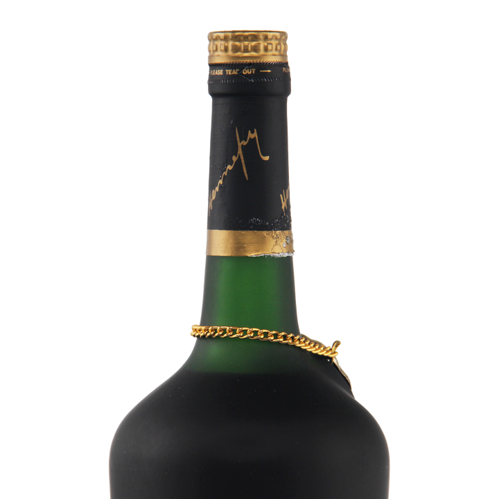Green wine bottle with gold foil cap and chain on a white background