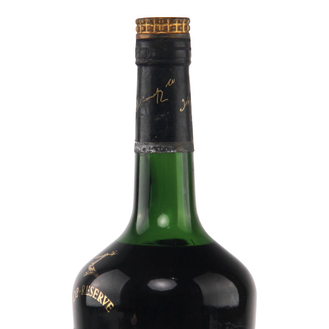 Green wine bottle with gold cap on a white background