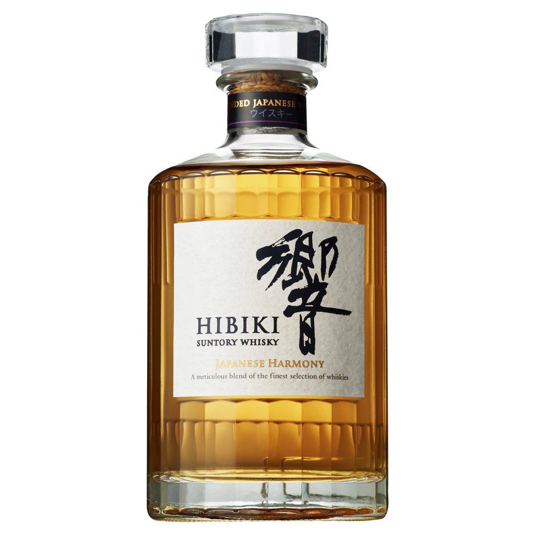 A bottle of Hibiki Japanese Harmony Blended Japanese Whisky features clear, ridged glass, amber liquid, a black and gold label with Japanese characters, and a transparent cap—an elegant showcase of Suntory’s whisky artistry.