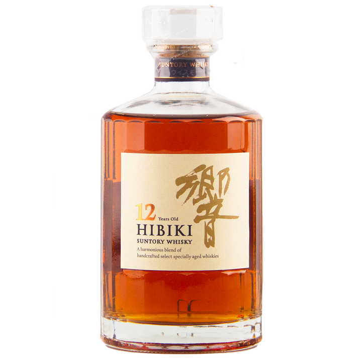 A bottle of Hibiki 12 Year Old Japanese Blended Whisky with amber liquid inside, a clear stopper, and a beige label featuring gold Japanese characters and black English text.