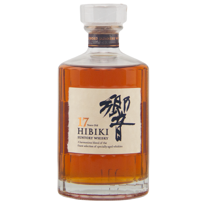 A bottle of Hibiki 17 Year Old Japanese Blended Malt Whisky in a clear glass decanter with stopper, white label with Japanese characters and details, and amber liquid crafted with rare Mizunara oak influence.