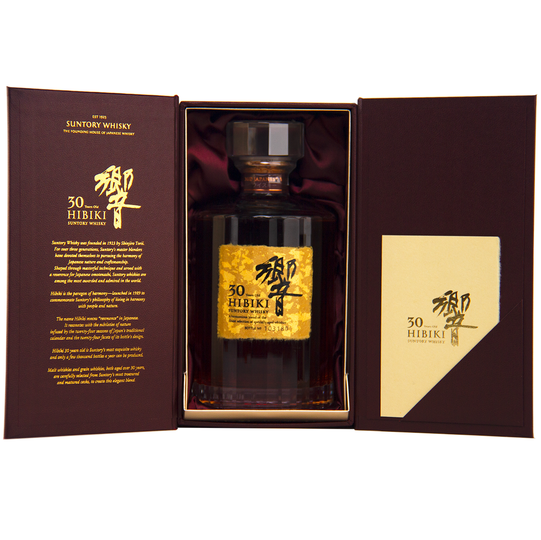 A bottle of Hibiki 30 Year Old Japanese Blended Malt Whisky in an open brown box with gold Japanese writing and an info card on the right. The label displays gold foil and elegant Japanese characters.
