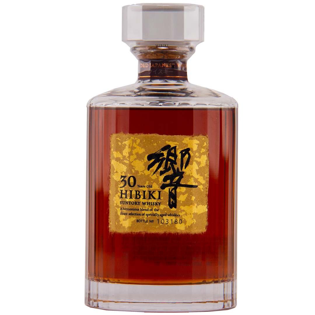 A bottle of Hibiki 30 Year Old Japanese Blended Malt Whisky features dark amber liquid, a gold label with black Japanese and English text, and a faceted glass stopper.