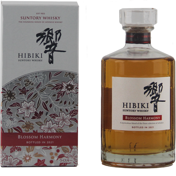 A bottle of Hibiki Blossom Harmony 2021 Japanese Blended Malt Whisky stands next to its floral-patterned box with Japanese text. This limited edition whisky was bottled in 2021.