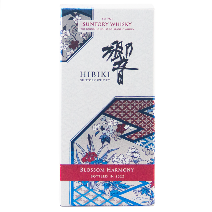 A box of Hibiki Blossom Harmony 2022 Limited Edition, Japanese whisky, with floral and geometric patterns in blue, white, and red. The red label highlights "Blossom Harmony Bottled in 2022.