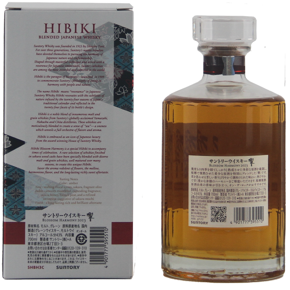 A bottle of Hibiki Blossom Harmony 2023 Japanese Blended Malt Whisky sits beside its box featuring product details and Japanese text. The tall bottle displays a clear label and contains the amber liquid of this limited edition release.